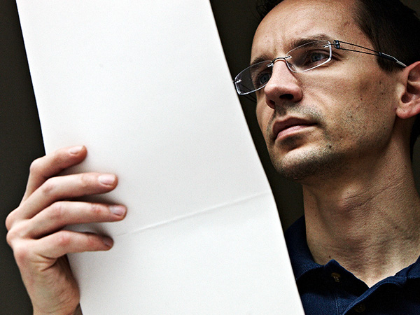 Man checking the quality of white paper.