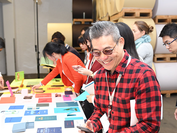 Man smiles while watching printed samples