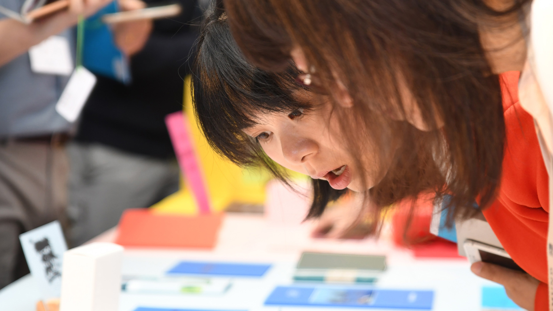 Women looking at printed samples during a workshop
