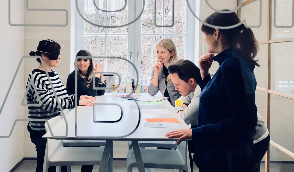 Workshop in a design lab. Woman feeling paper with closed eyes