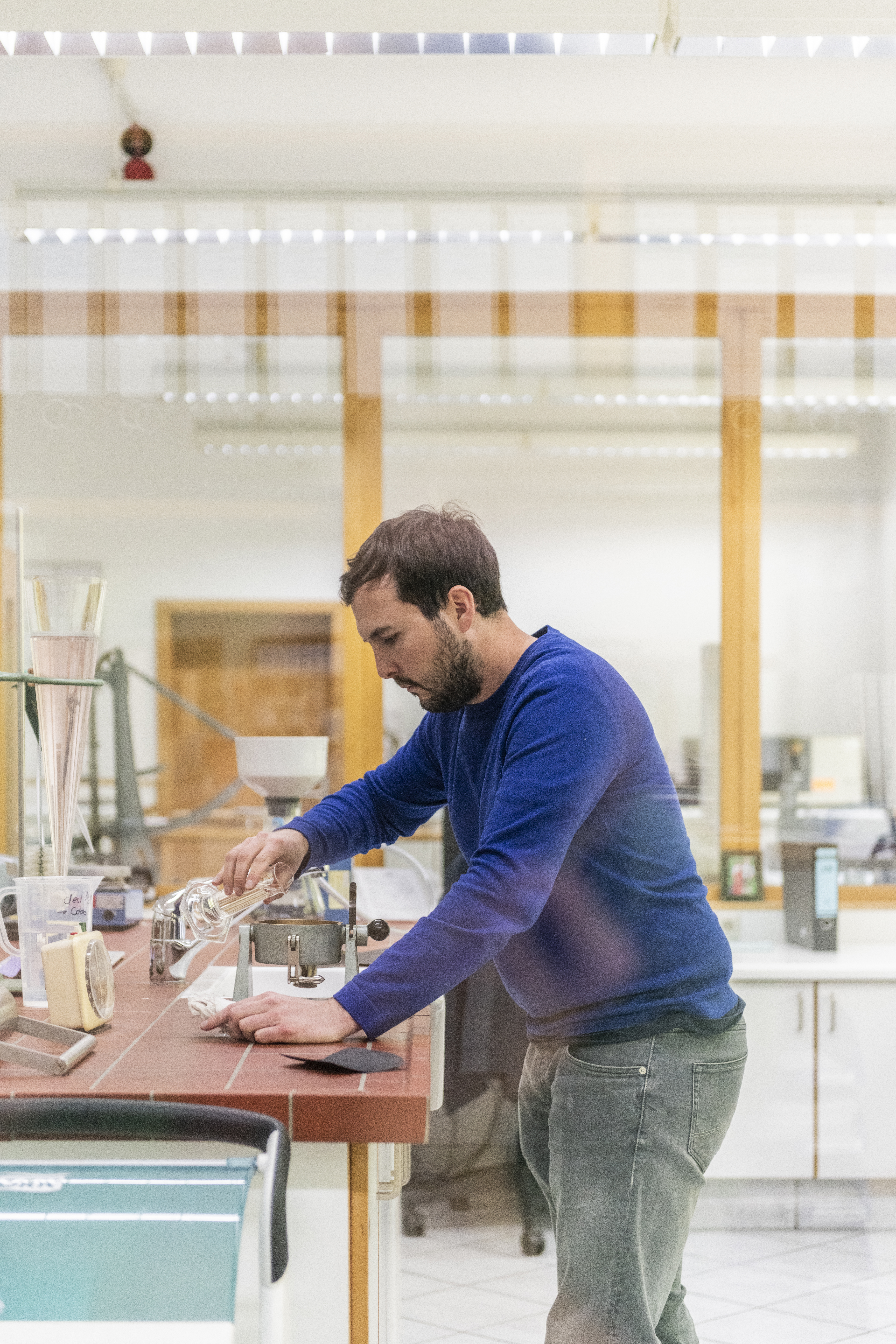 Mann in einem Labor testet Papierfasern